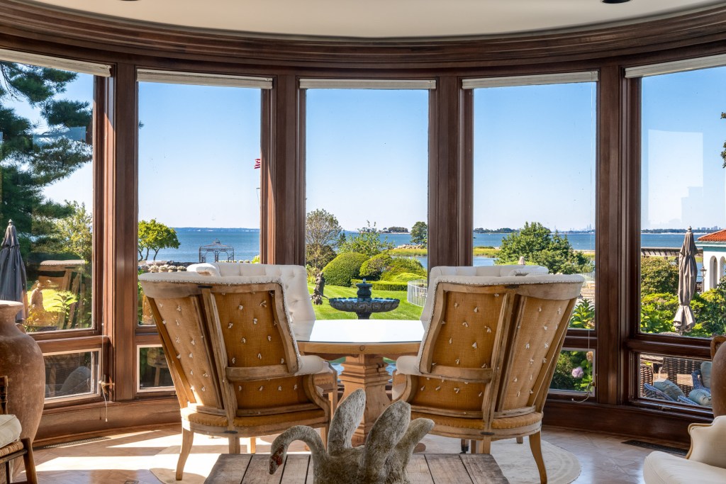 sunroom with seating looking over the Cedar Cliff estate from floor-to-ceiling windows