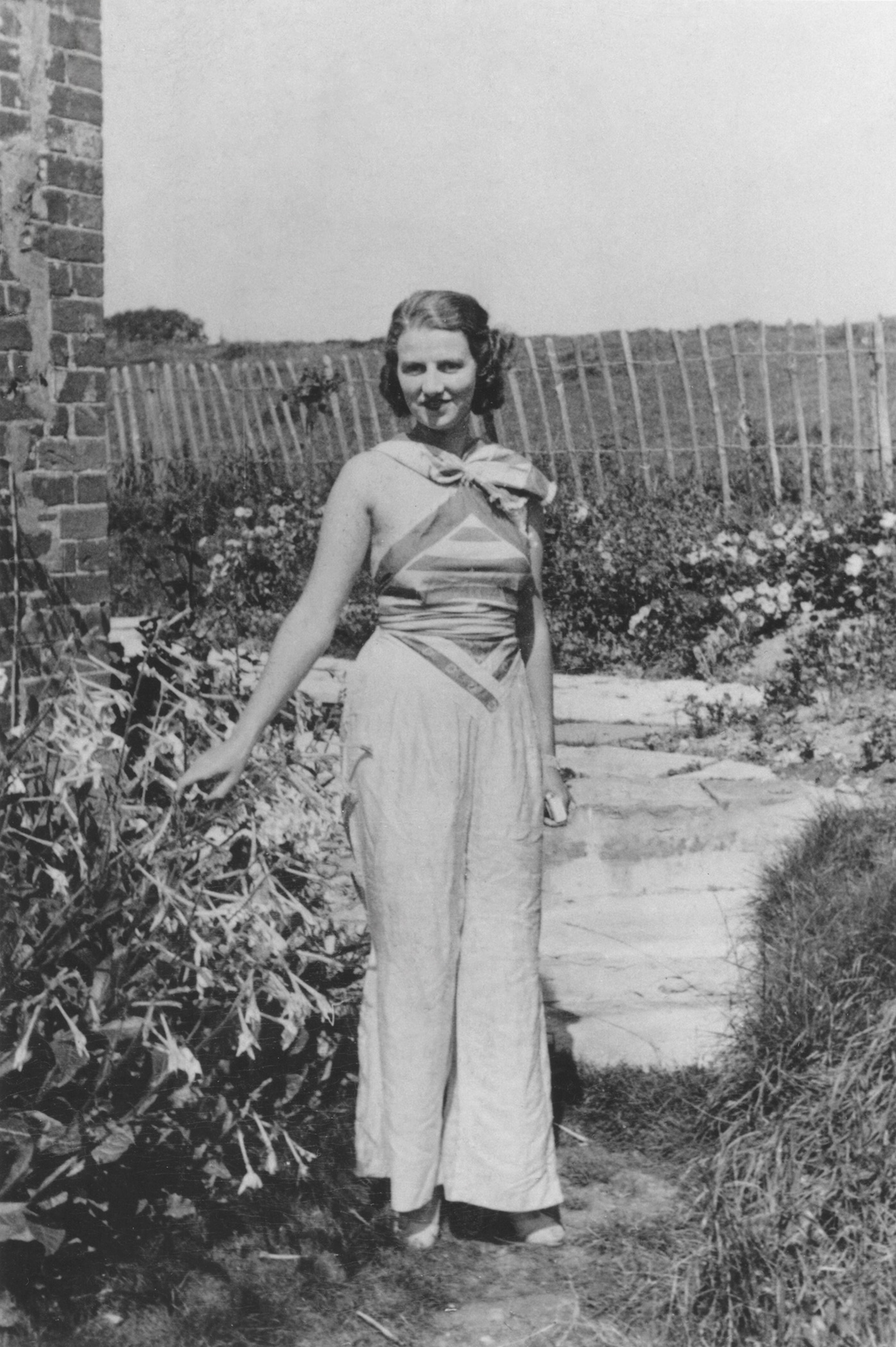 black and white photograph of Peggy Guggenheim standing outside
