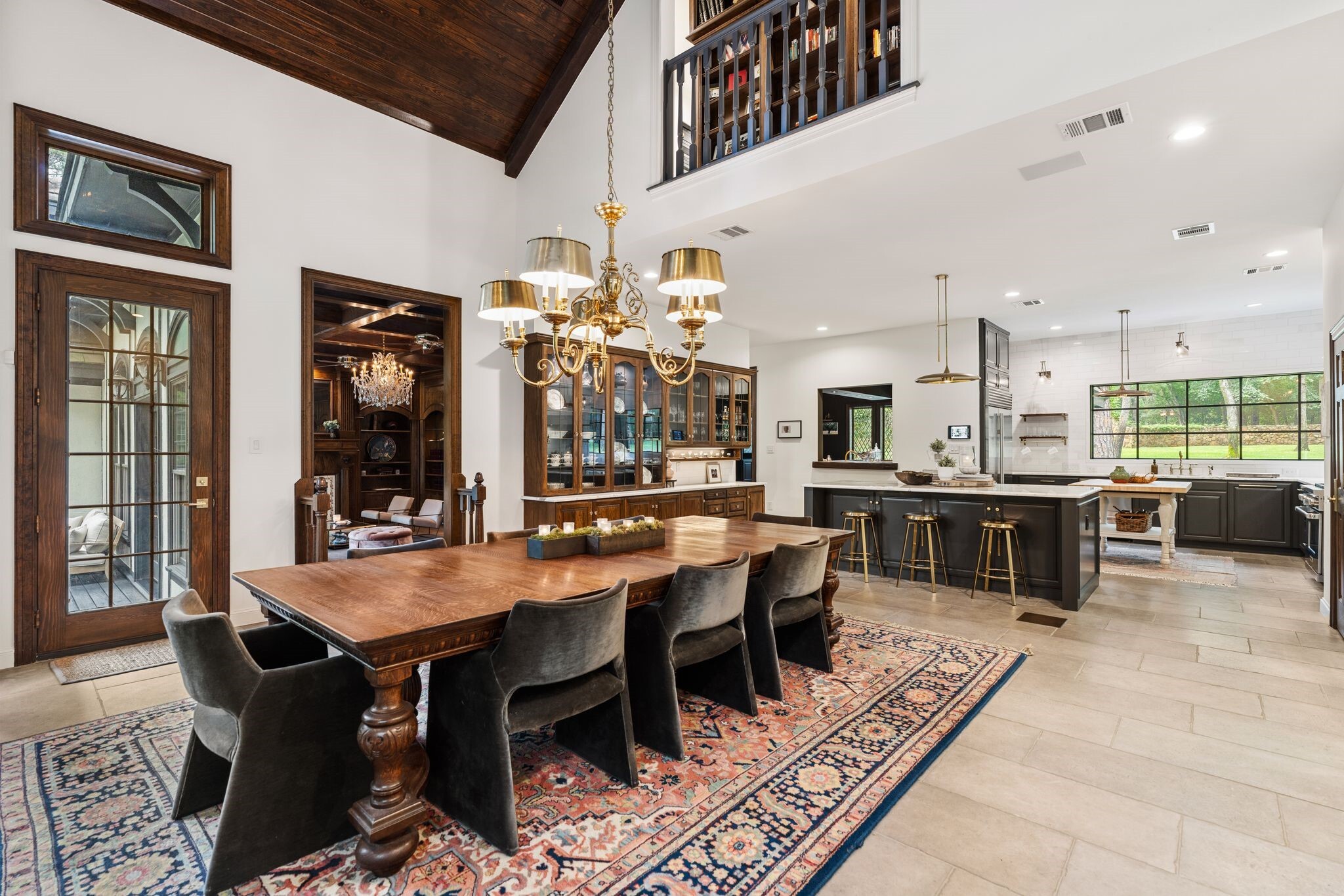 dining room flowing into chef's kitchen with built-in China cabinet in Texas home
