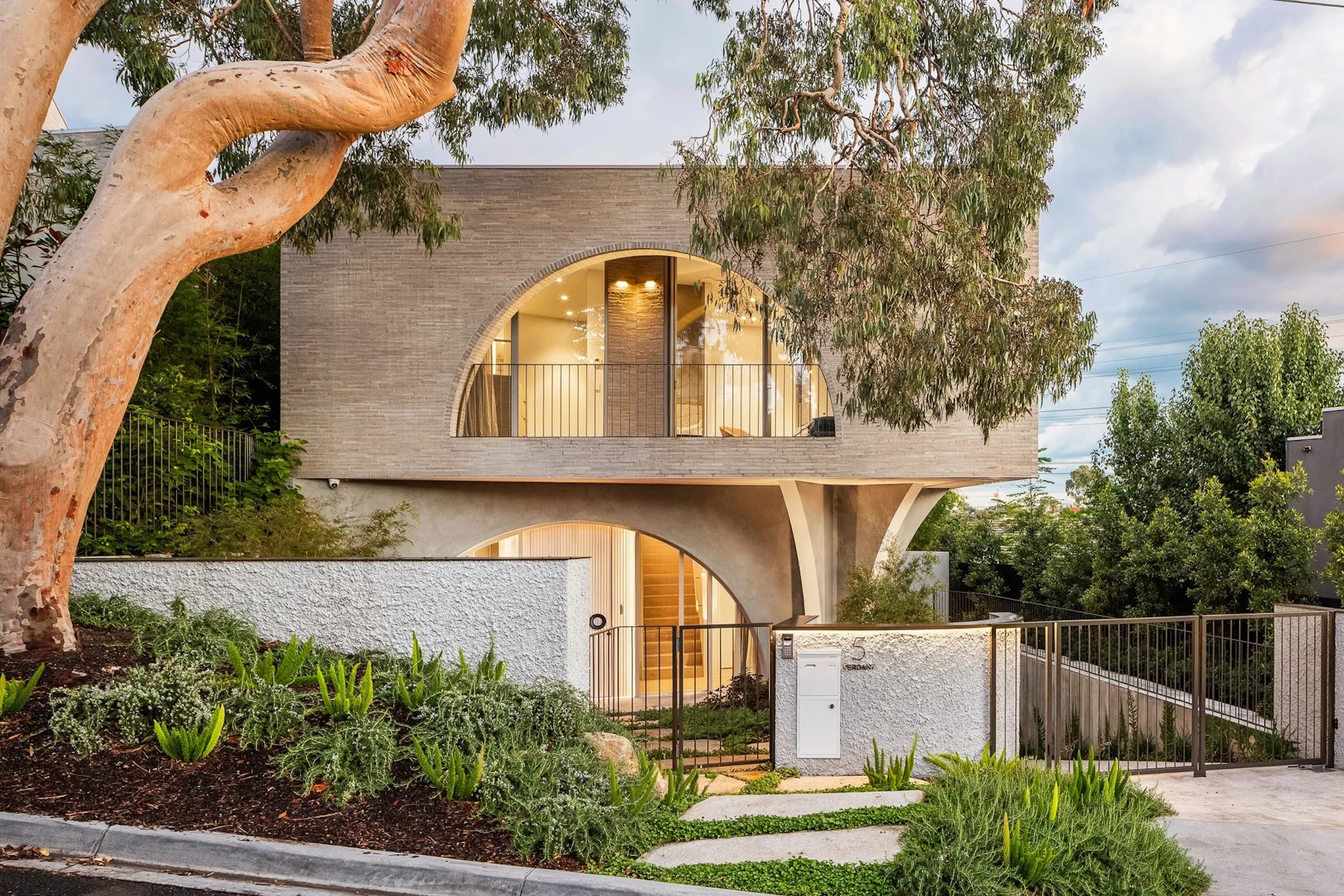 brick exterior of Melbourne home with rounded windows