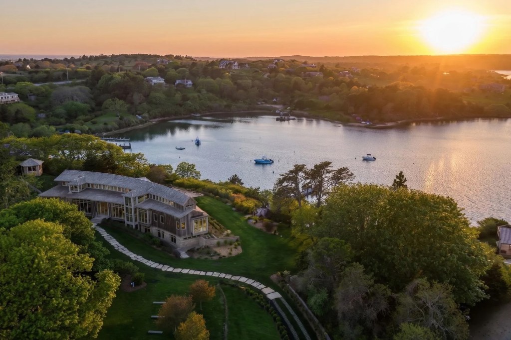 aerial view of home in Chilmark overlooking a body of water at sunset