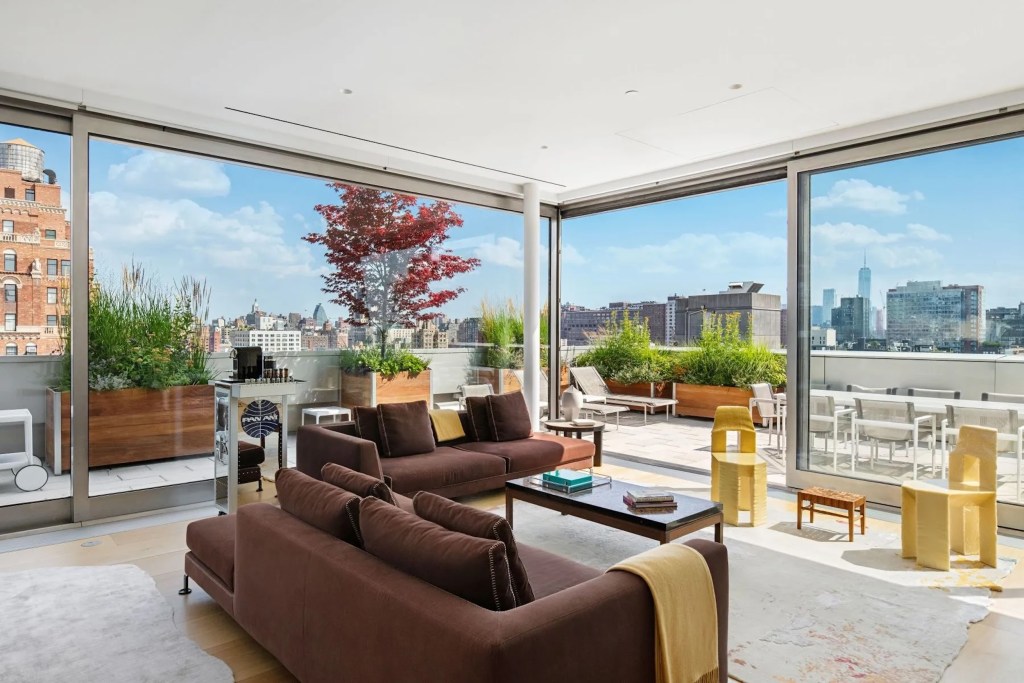 interior of New York City penthouse with panoramic city views through glass walls