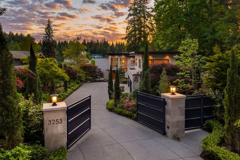 home on Washington lake behind gates with contemporary architecture at sunset
