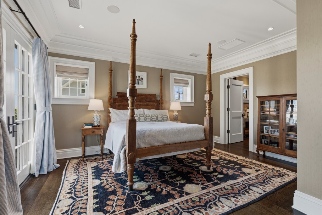 primary bedroom with french doors leading to private balcony