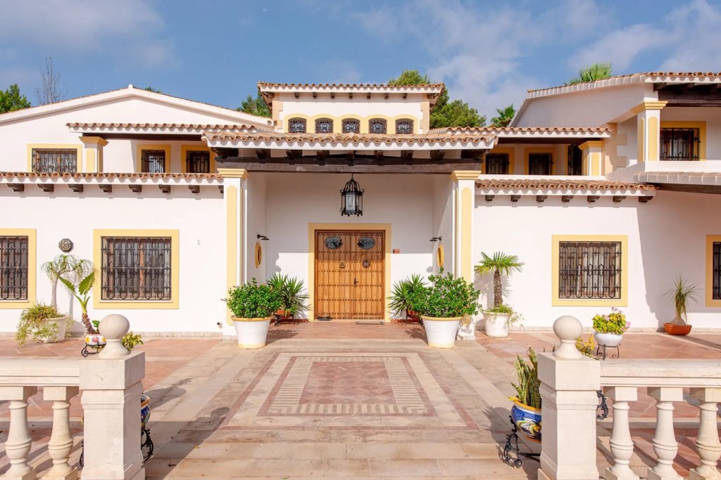 Exterior of home in Ibiza with terracotta courtyard