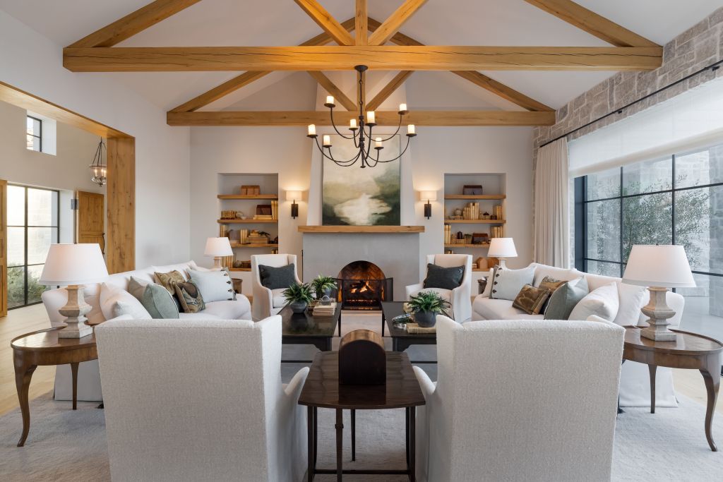 interior sitting room in Rancho Santa Fe home with exposed timber beams and fireplace