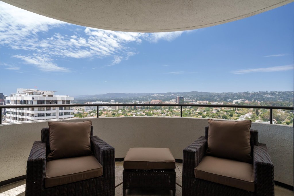 views of Los Angeles extending from penthouse balcony with seating