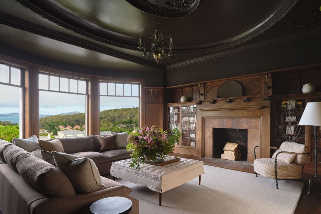 library with wood paneling and built ins in Presidio Heights home with panoramic windows, sofa, and table