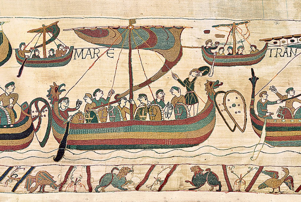 photo of The Bayeux Tapestry featuring soldiers in boats and various animals, located in the British Museum