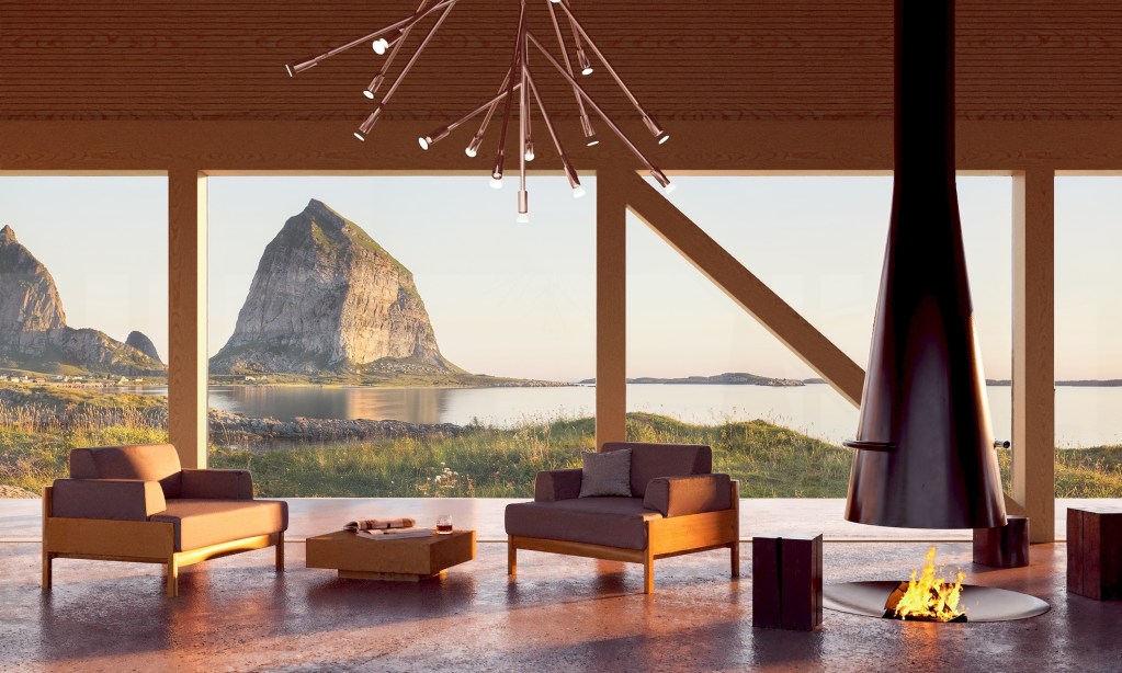 interior lounge in Ytri, a Norwegian retreat, showcasing seating and in- ground firepit, sculptural light fixture, and large windows facing rugged landscape, water, and large cliffside rock