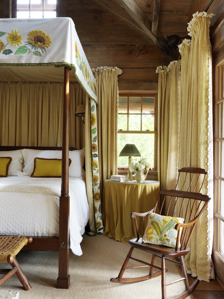 crewelwork by Sarah King on bed frame featuring sunflower motifs, rocking chair with embroidered cushion and yellow curtains