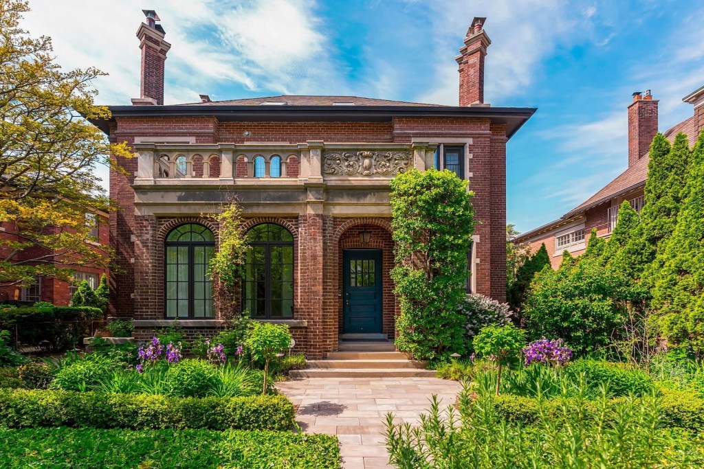 Exterior of Edwardian home with brick facade, stone details, and lush landscaping in Rosedale, Toronto 