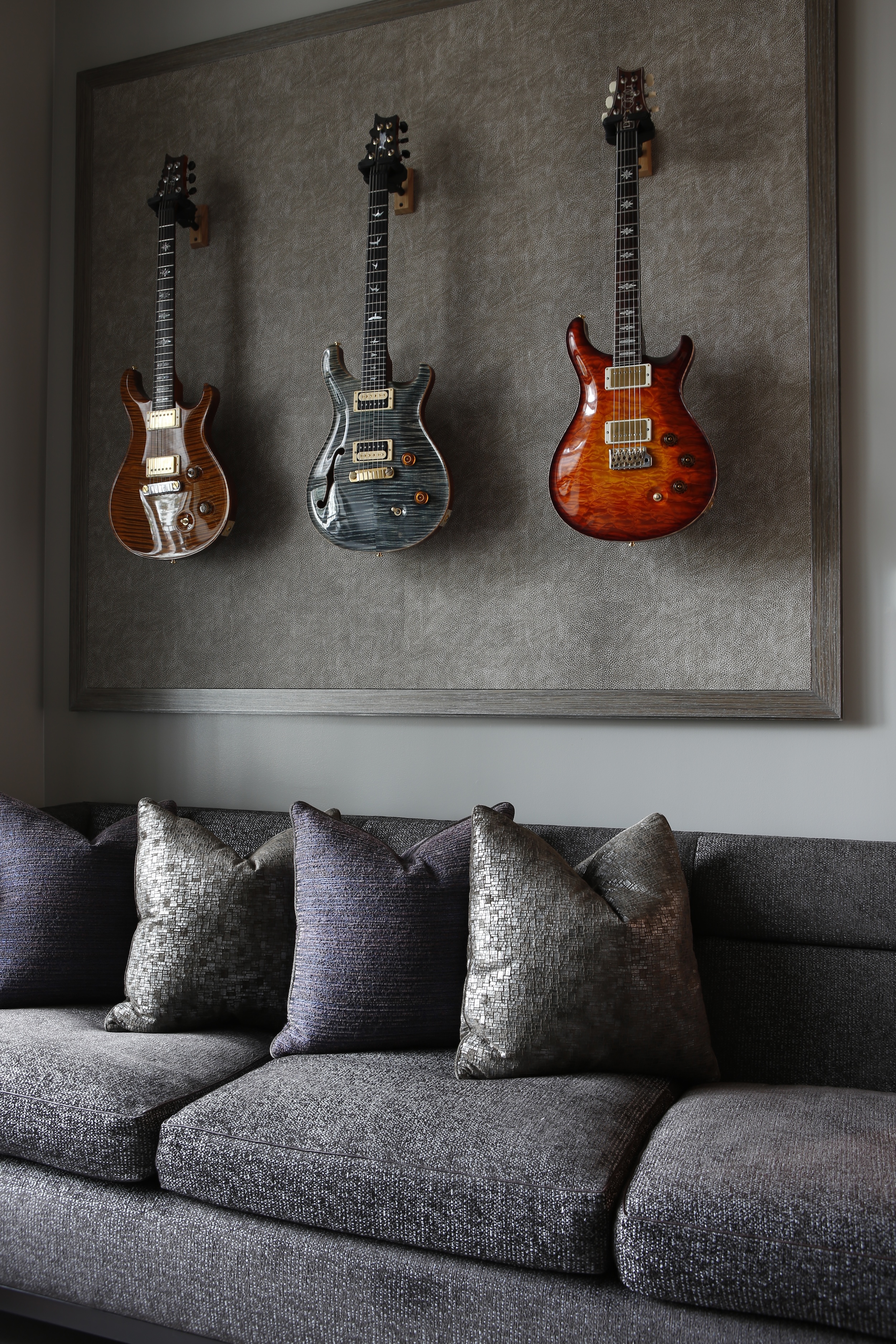 photo of bespoke zebrawood frame with leather backing displaying three electric guitars, by Phillip Thomas